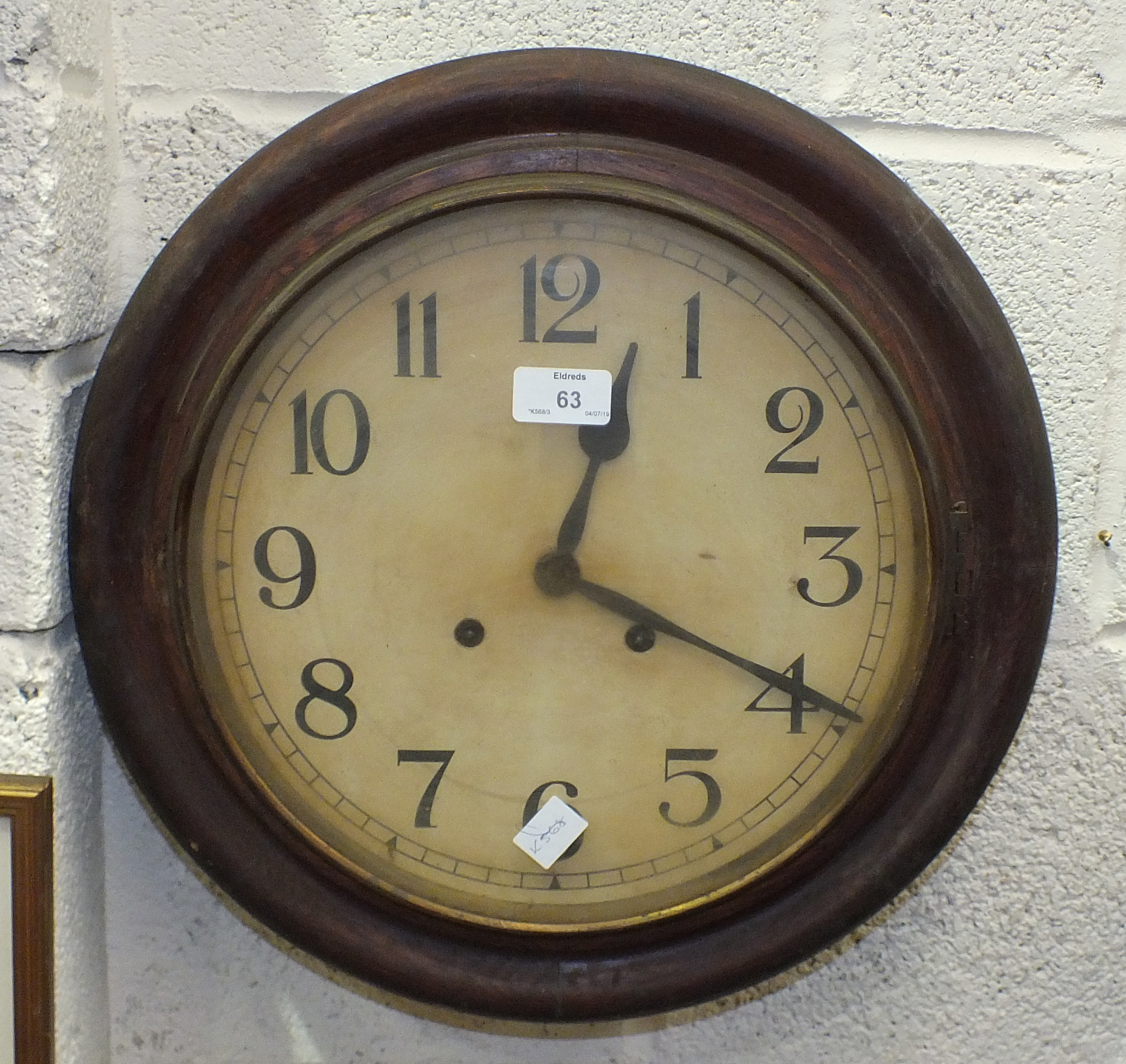 A stained wood circular striking wall clock, 40cm diameter, a mahogany finish striking wall clock,