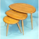 An Ercol nest of three light elm and beech 'Pebble' tables, largest 64cm wide, 41cm high.