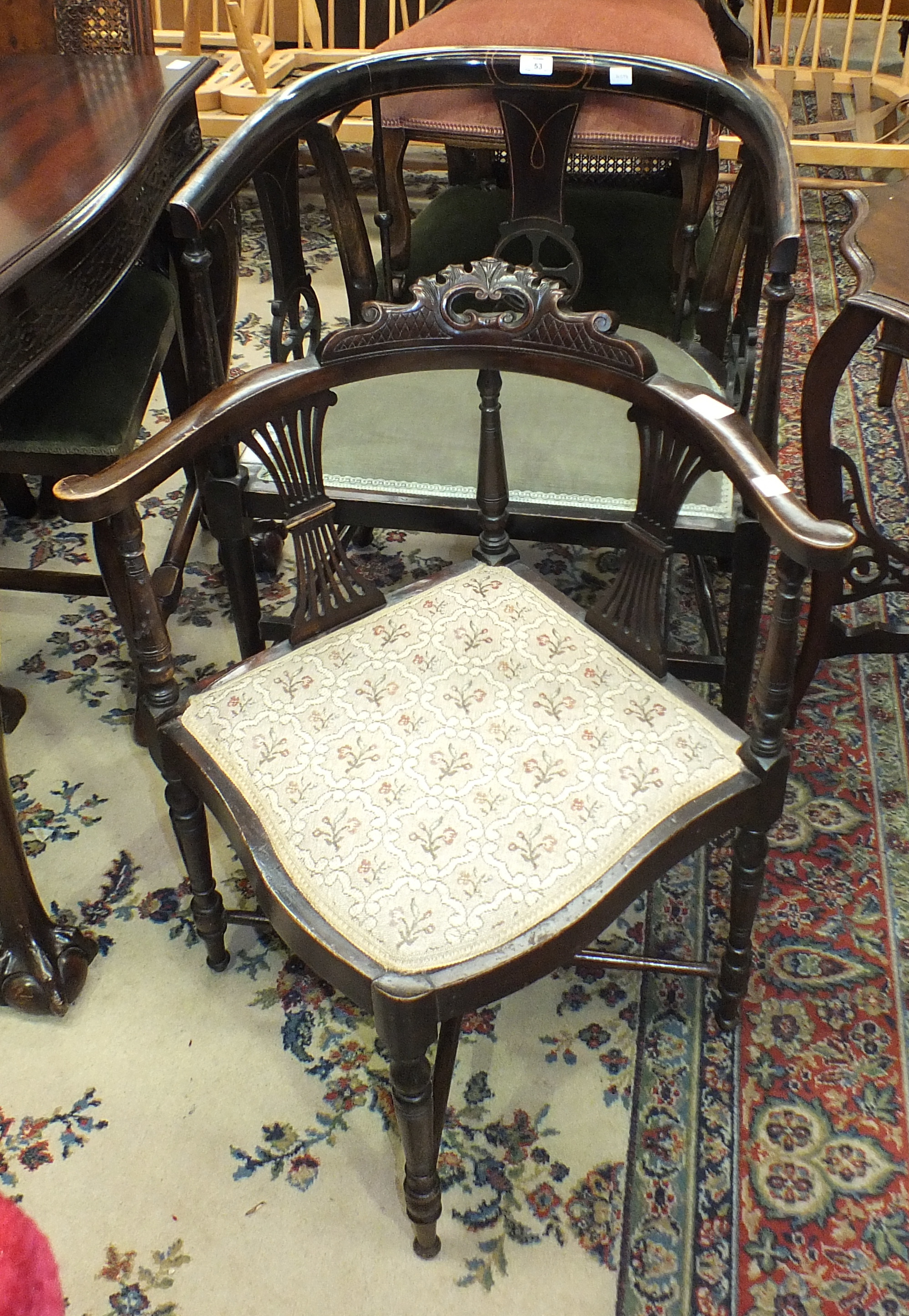 An Edwardian stained wood armchair with padded seat, an Edwardian corner chair, a caned-back