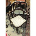 An Edwardian stained wood armchair with padded seat, an Edwardian corner chair, a caned-back