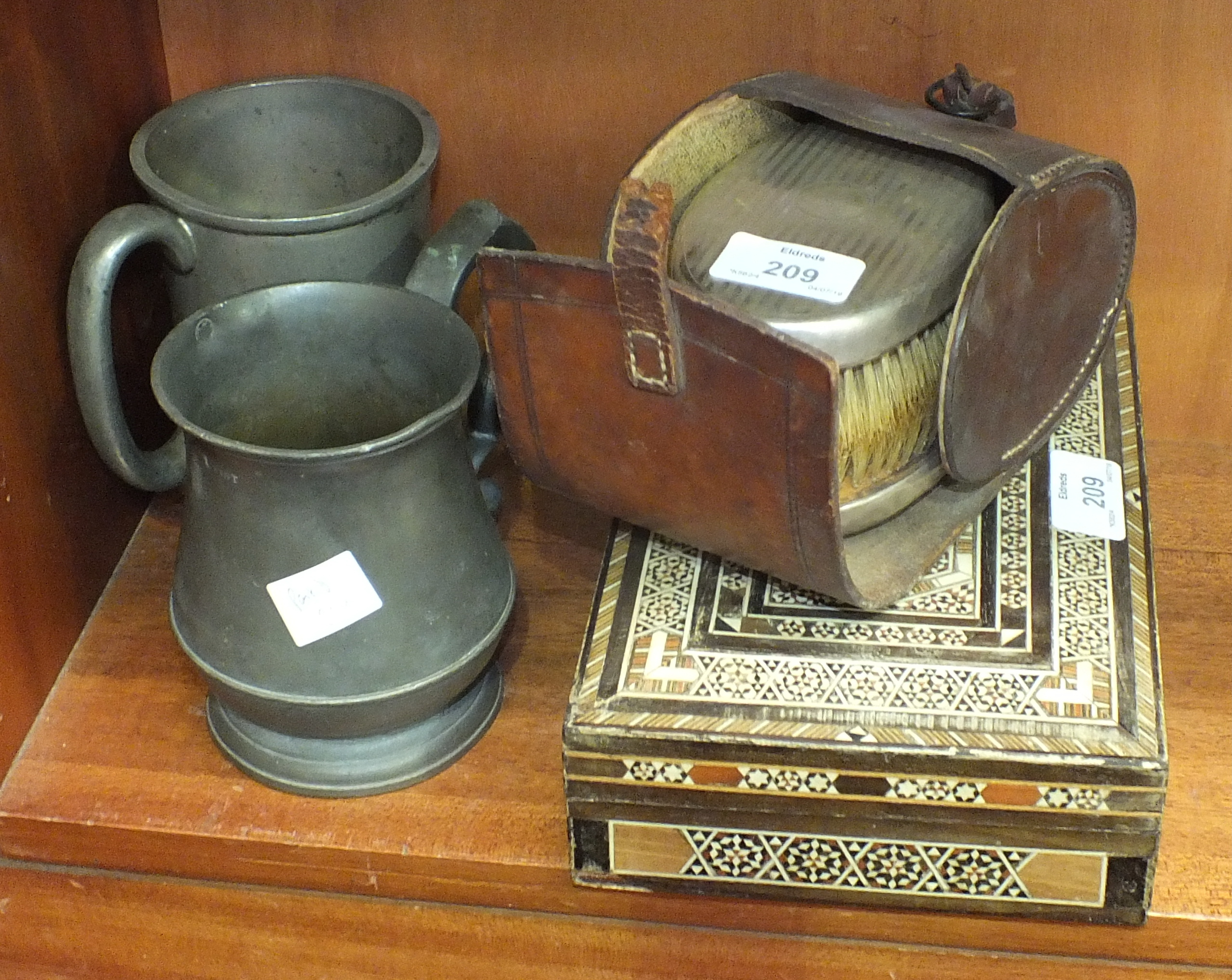 A pair of silver-backed clothes brushes, (marks rubbed), an inlaid box and two pewter tankards.