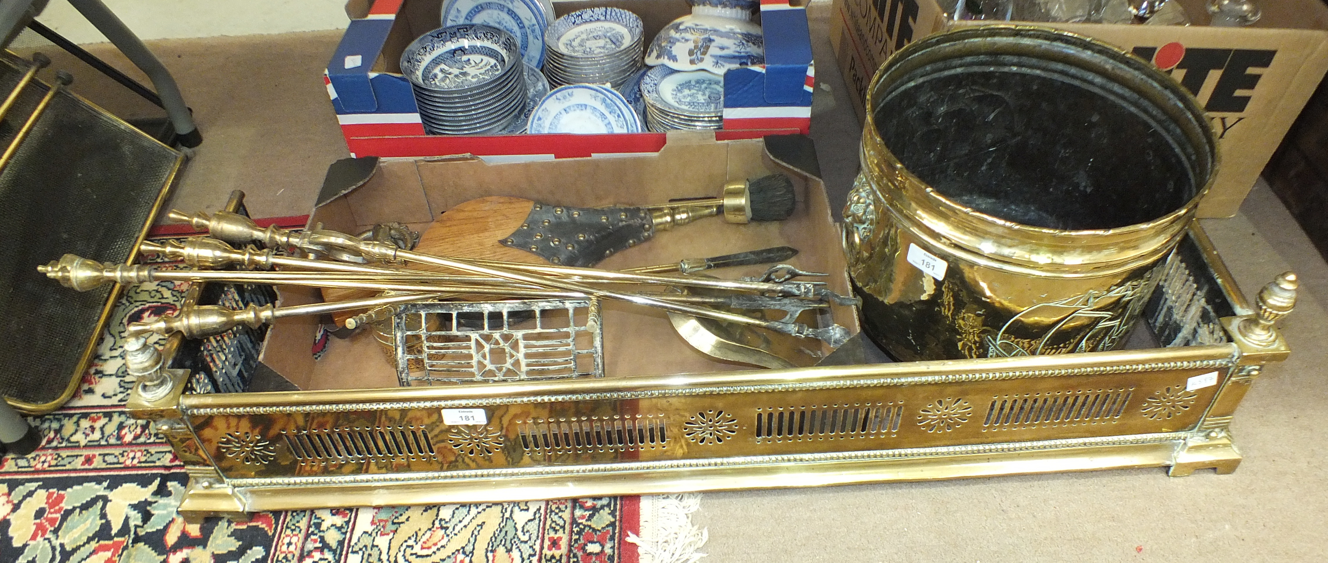 A brass pierced fire kerb, 105cm wide, a brass coal bucket, fire brasses, spark guard and other