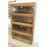 A Globe Wernicke oak finish four-section bookcase, 85cm wide, 142cm high.