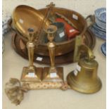 A brass/bronze bell with inscription, 13cm high overall, a brass circular tray and other metalware.