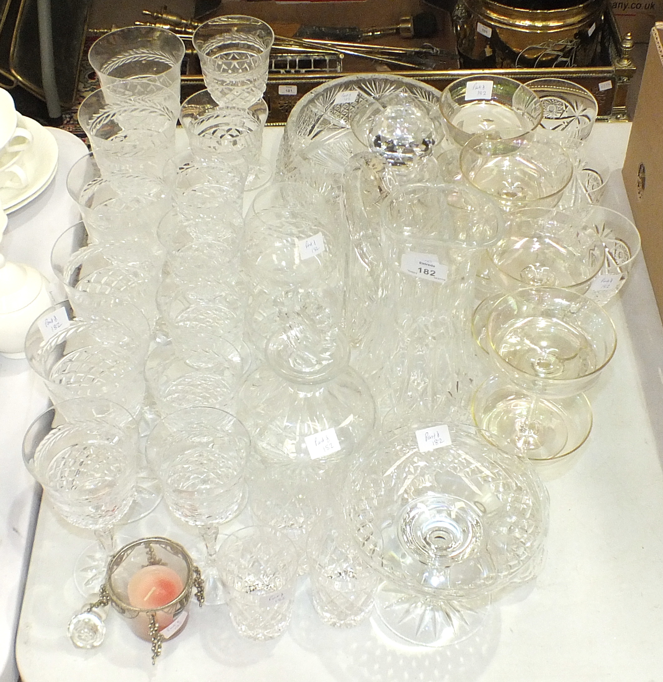 A cut-glass jug, two decanters, a bowl and a collection of various drinking glasses.