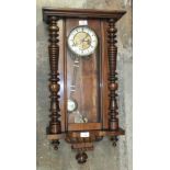 A late-19th/early-20th century stained wood Vienna-style striking wall clock, 74cm high.