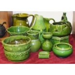 A group of green-glazed pottery jugs, bowls and vases, 14 pieces.