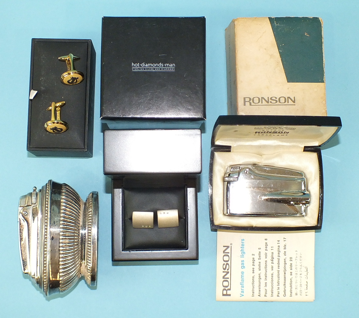 A Ronson table lighter with gadrooned decoration, a Ronson Varaflame lighter, boxed, a pair of