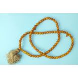 A string of butterscotch amber beads of uniform size, 9mm diameter, 37g.