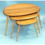 An Ercol nest of three light elm and beech 'Pebble' tables, largest 64cm wide, 41cm high.