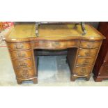 A reproduction mahogany serpentine shape knee-hole writing desk, 116cm wide.