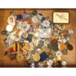 A quantity of badges, coins and medallions in an olive wood box.