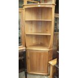 An Ercol light wood corner shelf unit/cabinet, 76cm wide, 179cm high and a small Ercol-style drop-