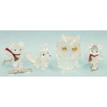 A collection of four boxed Swarovski crystal animal figures, comprising owl, bear with skates,
