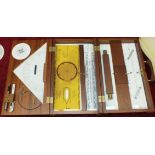 A modern Micron's Nautical Instruments box containing rolling and other rules, squares, etc.