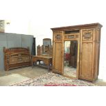 An Edwardian satin birch bedroom suite in the Aesthetic taste, comprising a large sectional wardrobe