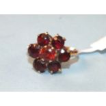 A garnet cluster ring with unmarked gold mount, size F, 3g.