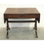 A Regency ebony-strung sofa table, the rectangular top with two drop leaves, above two cockbeaded