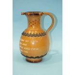 A Doulton Lambeth baluster-shaped puzzle jug with motto, 24cm high.