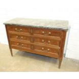 A late-19th century French walnut chest of three long drawers, within stock-fluted pilasters on