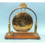 An Edwardian brass table-top dinner gong, on oak stand, with beater, 43cm wide, 44cm high and a