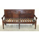 An 18th century mahogany settle with panelled back, on square legs joined by stretchers, 183cm