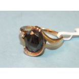 A 10k gold ring set haematite and a diamond point, size K, 3.1g.