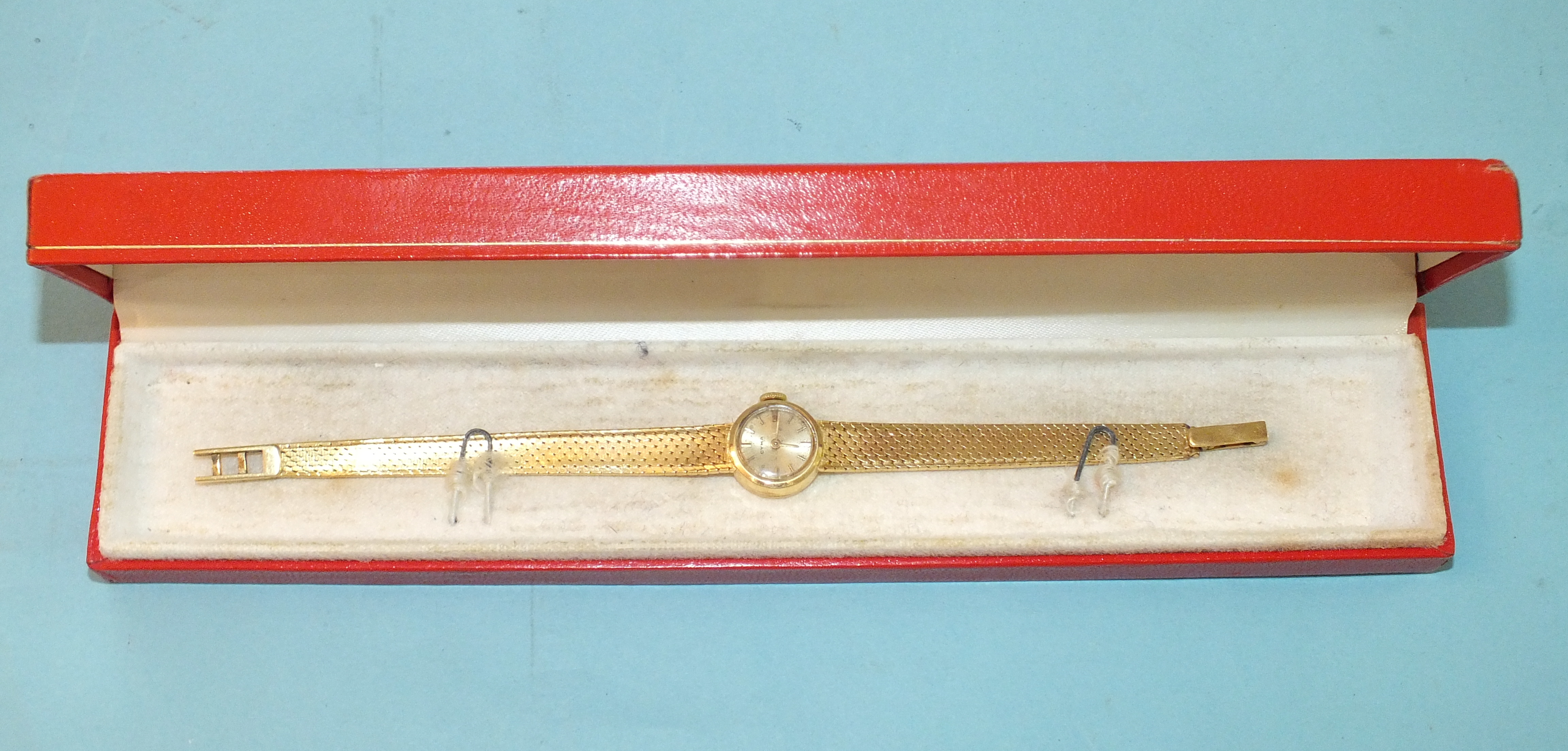 Cyma, a lady's 18ct-gold-cased wrist watch with 18ct gold integral bracelet, gross weight 24.3g.