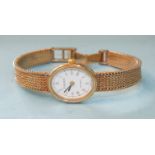 Tissot, a lady's quartz movement wrist watch with 9ct gold oval case and integral bracelet, 19.1g.