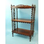 A small Victorian rosewood three-tier whatnot with spiral twist supports and fretwork panel, 51cm