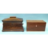 A sarcophagus-shaped mahogany tea caddy, the hinged lid revealing three lidded tea canisters, one