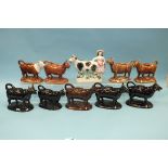 A collection of four Staffordshire-style ceramic cow creamers, with black and gilt-decorated body,