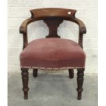 A mahogany tub shape library chair with upholstered seat, on turned legs.