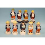 A collection of nine 19th century Staffordshire 'Toby' pepper pots, 13.5 - 16cm high, (some
