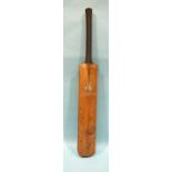 An old cricket bat stamped "Kennington Surrey Superior Warranted", with silver presentation