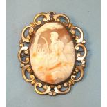A shell cameo brooch depicting a shepherd, in gold-plated scrolling mount, 69 x 54mm.