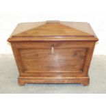 A Victorian mahogany sarcophagus-shaped wine cooler, the hinged lid and lead-lined interior on