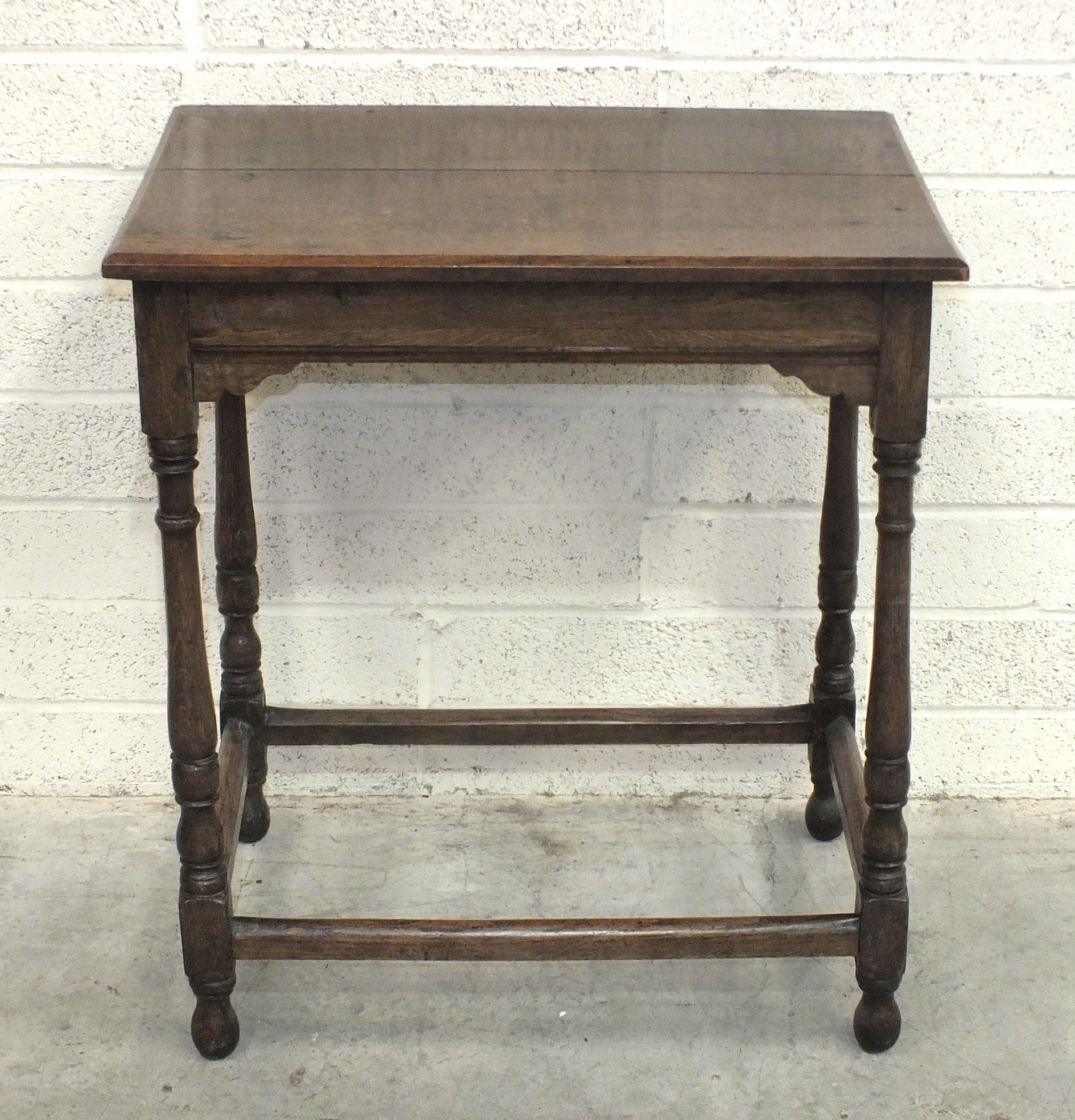 An antique oak rectangular occasional table, on turned legs joined by stretchers, 50 x 67cm.