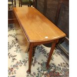 An antique mahogany oval drop-leaf table on turned legs and pad feet and four dining chairs.