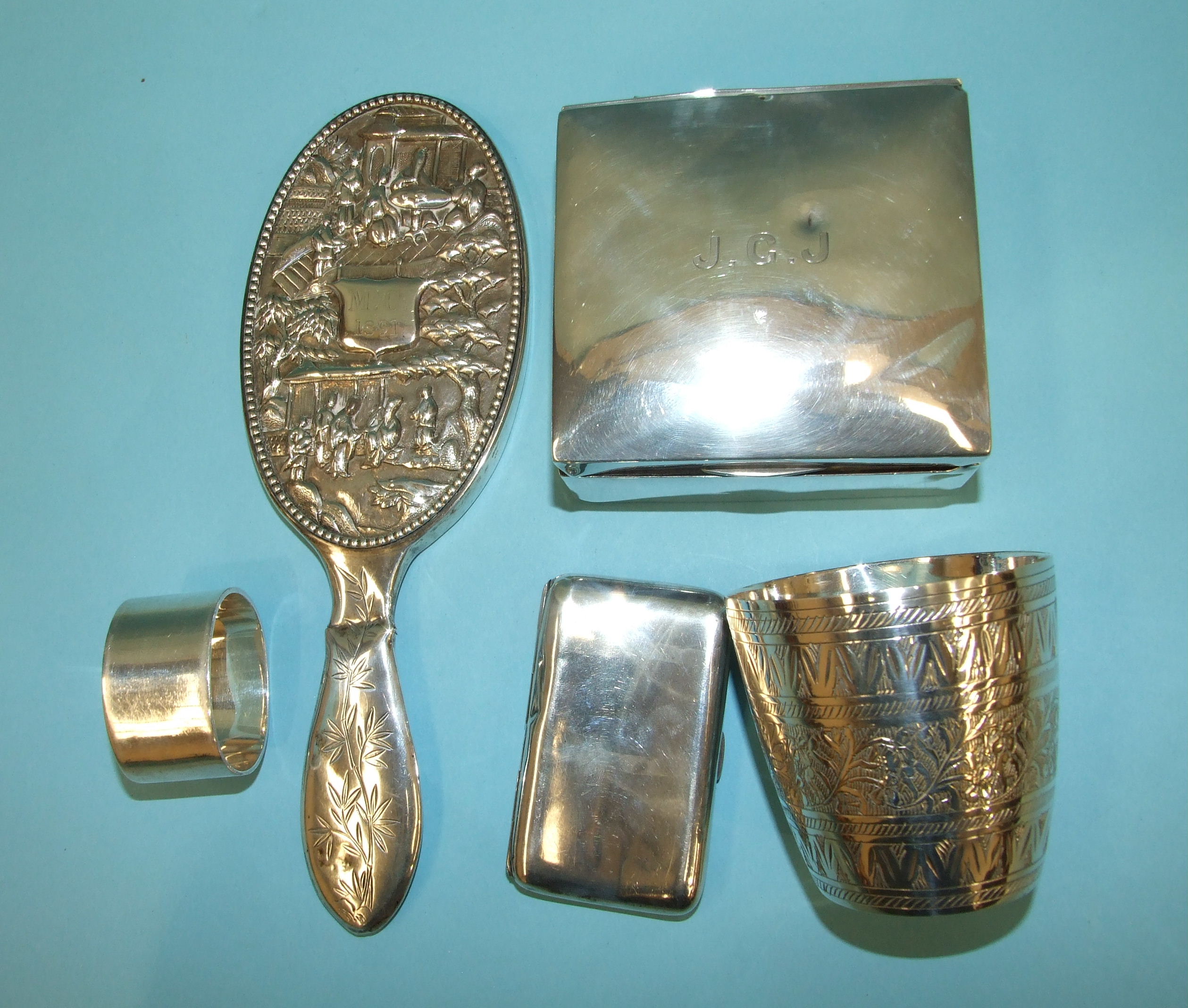 A silver cigarette case, Birmingham 1885, a modern plain silver napkin ring, London 1972 and other