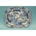 A 19th century blue and white meat plate decorated with a lakeland scene of figures on a raft,