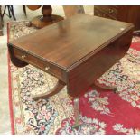 An early-19th century mahogany breakfast table, the rectangular top with two drop leaves above a