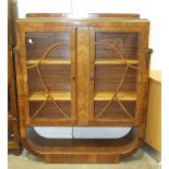 A 1930's walnut-veneered display cabinet, 110cm wide, 130cm high.