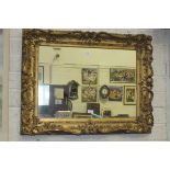 A rectangular mirror in carved gilt frame, 69 x 86cm overall.