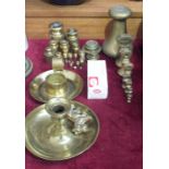 A collection of various brass weights, two brass candle holders, etc.