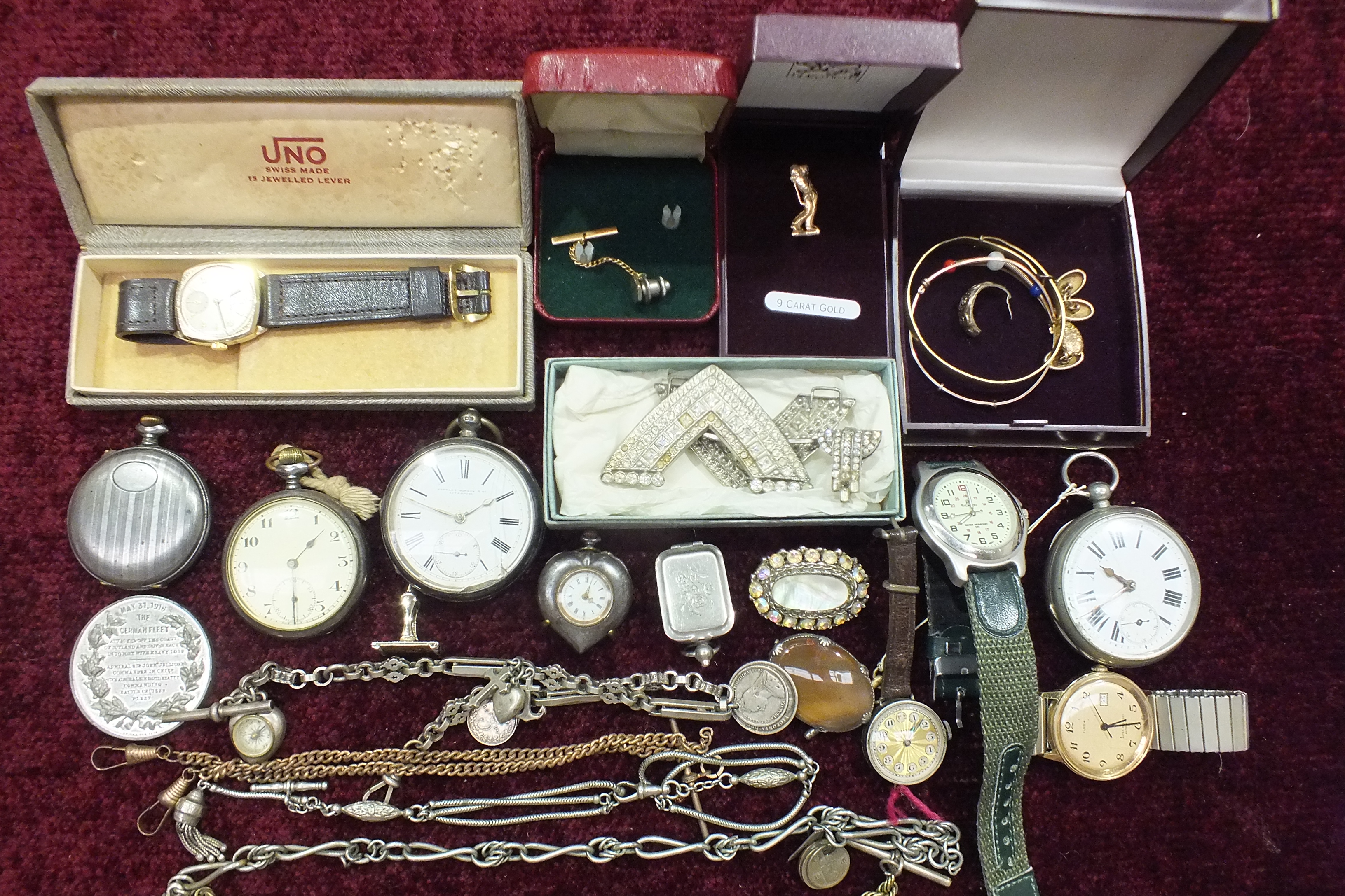 A collection of metal pocket watches, a steel heart-shaped fob watch and other items.