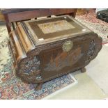 A 20th century camphor wood blanket chest with overall carved decoration, 101cm wide.