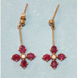 A pair of modern ruby and diamond drop earrings, each claw-set four rubies and a brilliant-cut