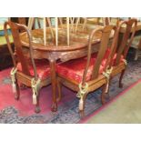 A modern Oriental hardwood extending dining table on cabriole legs, the top with inlaid decoration