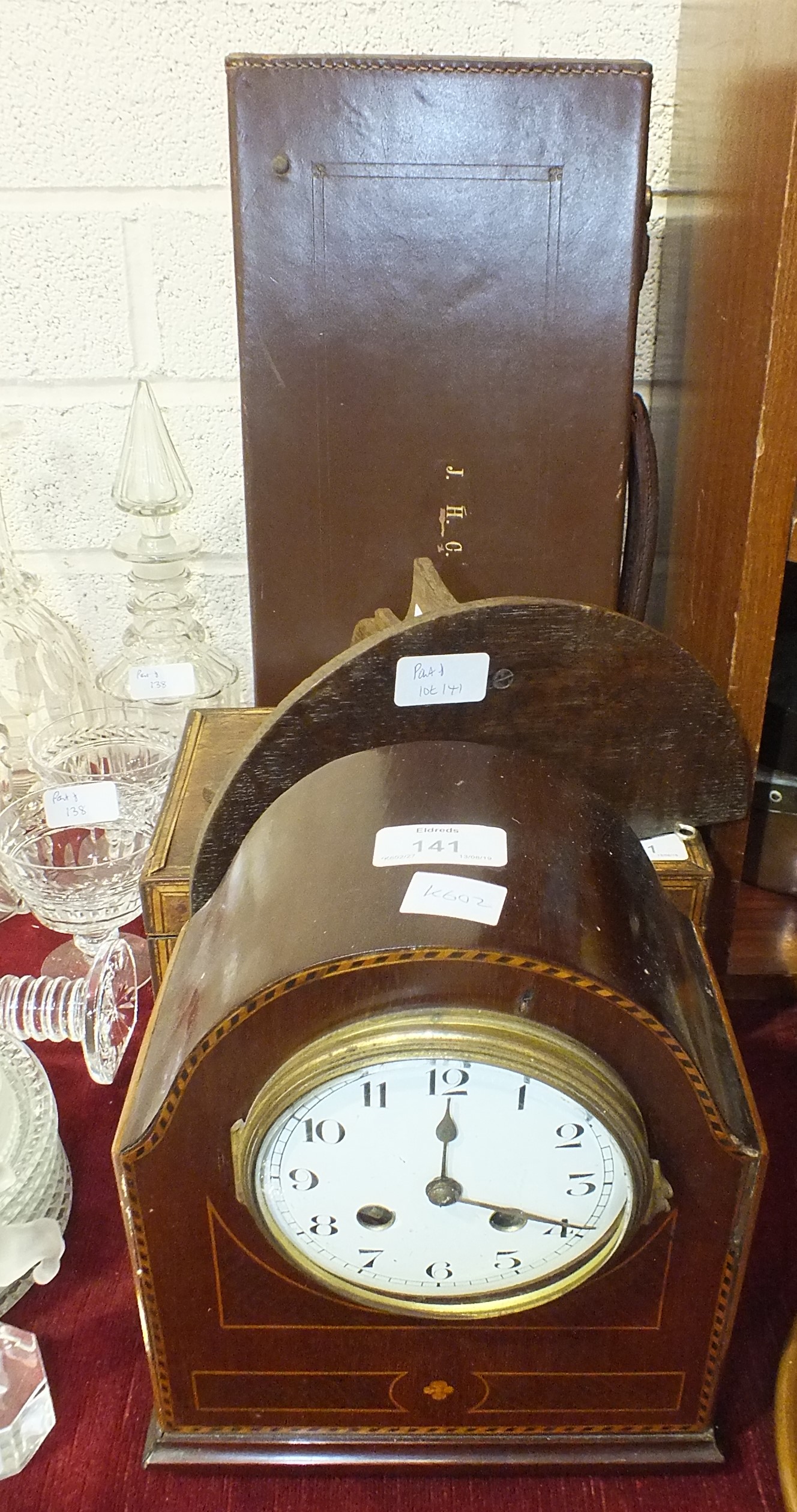 An inlaid mahogany-cased striking mantel clock, 24cm high, (a/f), a leather Masonic case and other